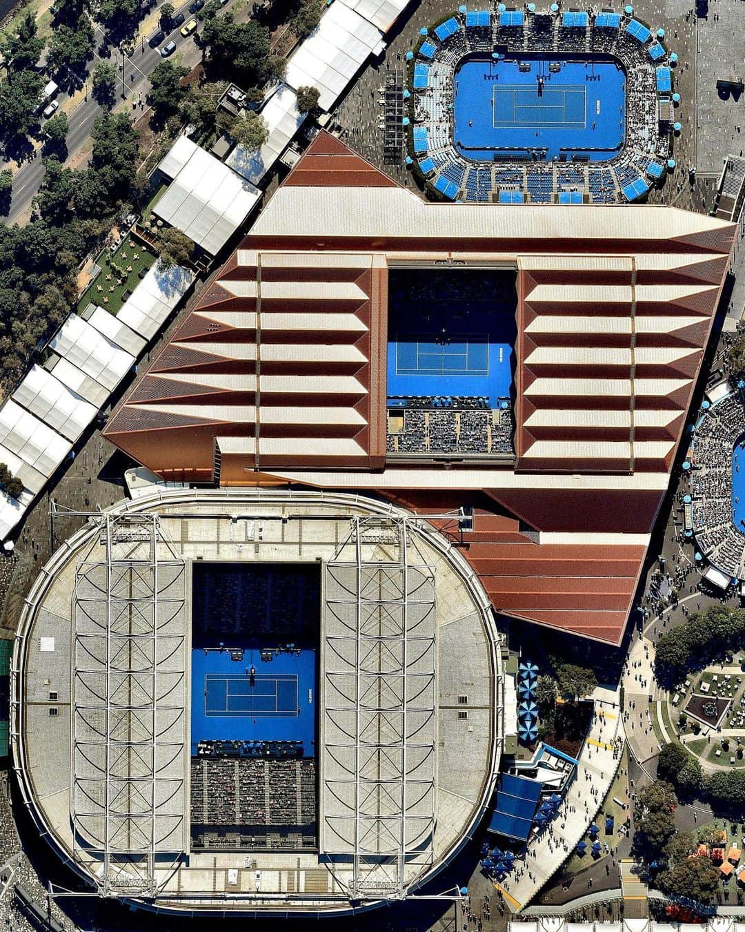 Daily Overviewのインスタグラム：「Melbourne Park in Melbourne, Australia, has been the home of the Australian Open tennis tournament since 1988. Held annually during the last two weeks of January (though later this year due to COVID-19), the tournament is the first of the four Grand Slam tennis events, preceding the French Open, Wimbledon and the US Open. Today, Naomi Osaka clinched the women’s singles title over Jennifer Brady, and tomorrow Novak Djokovic will face off against Daniil Medvedev in the men’s singles final. — Created by @overview Source imagery: @nearmap」