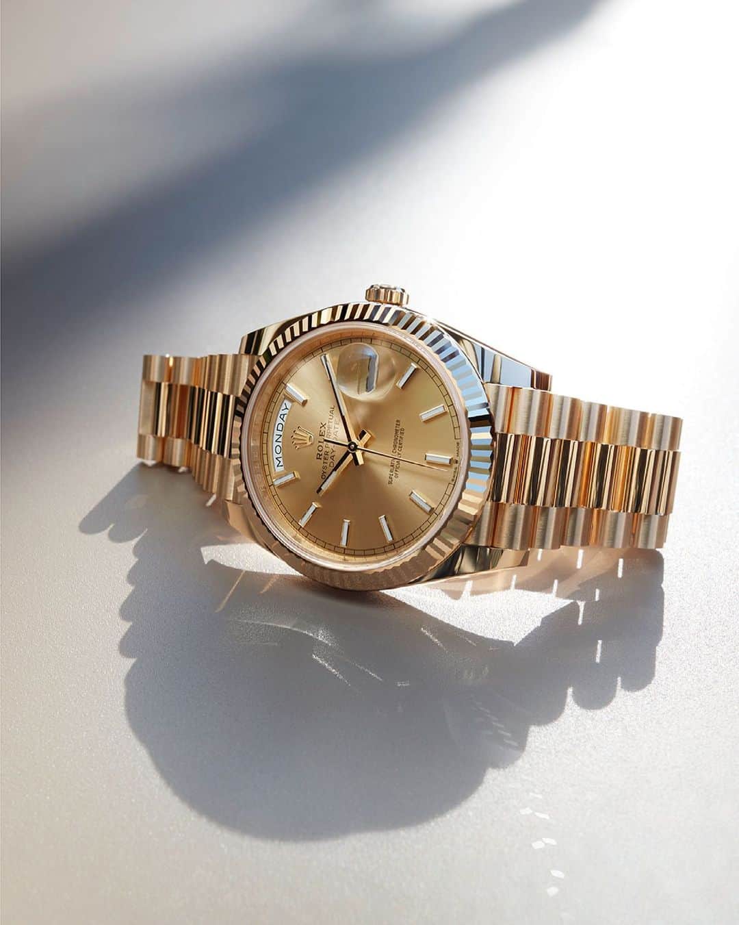 rolexのインスタグラム：「With its sunray finish, the Day-Date 40’s champagne-colour dial emits delicate light reflections that complement the lustre and prestige of the 18ct yellow gold fluted bezel, case and bracelet. #Rolex #DayDate #101031」