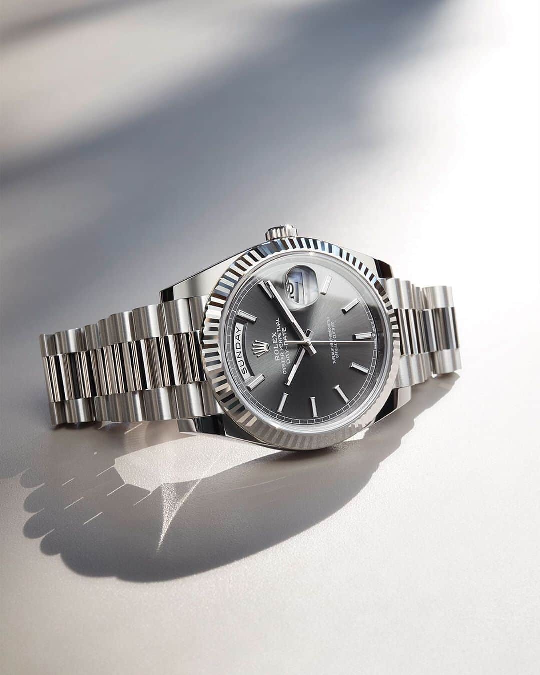 rolexのインスタグラム：「The Day-Date 40’s slate dial, combined with the 18ct white gold fluted bezel, Oyster case and President bracelet, gives this exclusive version a subtle yet incomparable glow. #Rolex #DayDate #101031」